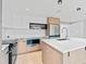 Modern kitchen with a large island, sleek countertops, and stainless steel appliances at 1972 Sourwood Blvd, Dunedin, FL 34698