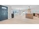 Bright, open-concept living area featuring hardwood floors, ample natural light, and a modern kitchen at 1972 Sourwood Blvd, Dunedin, FL 34698