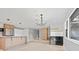 Open concept living room with wet bar and kitchen featuring island, and bright natural light at 1972 Sourwood Blvd, Dunedin, FL 34698