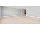 Spacious room with light wood floors and neutral wall paint at 1972 Sourwood Blvd, Dunedin, FL 34698