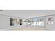 Bright living room featuring large windows with backyard views and a white door at 1972 Sourwood Blvd, Dunedin, FL 34698