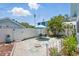 Enclosed backyard patio with landscaping, plants, and table with chairs at 210 15Th N Ave, St Petersburg, FL 33704