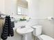Cozy bathroom with pedestal sink, sleek fixtures, and neutral decor at 210 15Th N Ave, St Petersburg, FL 33704