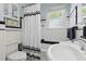 Bathroom featuring black and white tile, vanity, toilet, and tiled shower with curtain at 210 15Th N Ave, St Petersburg, FL 33704