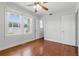 Sunny bedroom featuring hardwood floors, a ceiling fan, and two windows at 210 15Th N Ave, St Petersburg, FL 33704