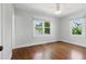 Bedroom featuring hardwood floors, white trim, and two large windows at 210 15Th N Ave, St Petersburg, FL 33704