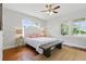 Bright bedroom featuring hardwood floors, ceiling fan and dual windows for ample natural light at 210 15Th N Ave, St Petersburg, FL 33704