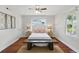 Bright bedroom featuring hardwood floors, ceiling fan and dual windows for ample natural light at 210 15Th N Ave, St Petersburg, FL 33704