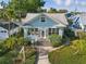 Charming light blue home featuring a landscaped front yard, sidewalk and a white picket mailbox at 210 15Th N Ave, St Petersburg, FL 33704