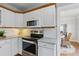 Bright kitchen features white cabinets, stainless steel appliances, granite countertops, and tile backsplash at 210 15Th N Ave, St Petersburg, FL 33704