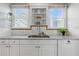 Kitchen featuring sleek countertops, built-in shelving, and stainless steel sink at 210 15Th N Ave, St Petersburg, FL 33704