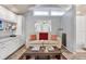 Cozy living room featuring wood-look floors, neutral sofa, and a rustic coffee table at 210 15Th N Ave, St Petersburg, FL 33704