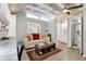 Bright living room area with a neutral sofa, wood floors, and connecting bathroom at 210 15Th N Ave, St Petersburg, FL 33704