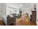 Inviting living room with hardwood floors, a brick fireplace, neutral-toned furniture, and abundant natural light at 210 15Th N Ave, St Petersburg, FL 33704