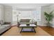 The living room has a bay window, neutral furniture, hardwood floors and an area rug at 210 15Th N Ave, St Petersburg, FL 33704