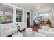 The sun room, with tiled floors and lots of windows, functions as a transitional space with seating and a table at 210 15Th N Ave, St Petersburg, FL 33704