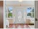 The sun room features brick floors, a decorative door, sidelights and lots of windows at 210 15Th N Ave, St Petersburg, FL 33704