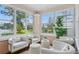 Bright sunroom featuring brick floors, large windows, and comfortable seating, creating a welcoming atmosphere at 210 15Th N Ave, St Petersburg, FL 33704