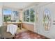 Sun room with brick floors, large windows, a desk and chair, offering bright and airy space at 210 15Th N Ave, St Petersburg, FL 33704