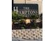The Hamptons community sign with manicured landscaping adds curb appeal at 224 Red Maple Pl # 224, Brandon, FL 33510