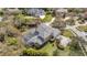 Aerial view of the backyard featuring a screened-in pool, lush landscaping, and a sprawling lawn at 2280 Mackenzie Ct, Clearwater, FL 33765