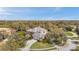 Expansive aerial view showcases the property's well-manicured lawn and mature trees at 2280 Mackenzie Ct, Clearwater, FL 33765