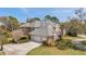Stunning aerial view of a house showcasing its roof, three-car garage, and lush green surroundings at 2280 Mackenzie Ct, Clearwater, FL 33765