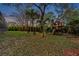 Expansive backyard featuring a wooden playset with slide and swings for outdoor enjoyment at 2280 Mackenzie Ct, Clearwater, FL 33765