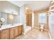Bathroom with double vanity, large mirror, shower and bathtub combination, and tile flooring at 2280 Mackenzie Ct, Clearwater, FL 33765