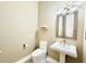Elegant powder room with pedestal sink, decorative mirror and sconce lighting at 2280 Mackenzie Ct, Clearwater, FL 33765
