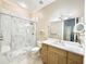 The modern bathroom showcases a glass-enclosed shower and vanity with marble countertops and contemporary lighting at 2280 Mackenzie Ct, Clearwater, FL 33765