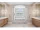 Bathroom featuring a tub with columns and dual vanities at 2280 Mackenzie Ct, Clearwater, FL 33765