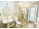 Modern bathroom featuring a glass-enclosed shower, sleek fixtures, and stylish lighting at 2280 Mackenzie Ct, Clearwater, FL 33765