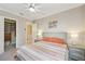 Cozy bedroom with neutral walls, ceiling fan, walk-in closet and plenty of natural light at 2280 Mackenzie Ct, Clearwater, FL 33765