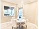 Bright breakfast nook features modern lighting, a round table, and views of the outdoor pool area at 2280 Mackenzie Ct, Clearwater, FL 33765