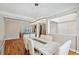 Open dining area with hardwood floors, natural light, and a modern chandelier adjacent to the living room at 2280 Mackenzie Ct, Clearwater, FL 33765