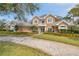 Stunning two-story home showcasing meticulous landscaping, a welcoming front porch, and elegant architectural details at 2280 Mackenzie Ct, Clearwater, FL 33765
