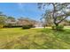 Beautiful home with manicured lawn, mature trees, and a three-car garage at 2280 Mackenzie Ct, Clearwater, FL 33765