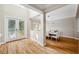 Bright foyer with hardwood floors, a decorative glass front door, and a view of the dining area at 2280 Mackenzie Ct, Clearwater, FL 33765