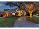 Exterior twilight view of a two-story home with a brick driveway at 2280 Mackenzie Ct, Clearwater, FL 33765