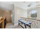 Second floor hallway with view of air hockey table and a decorative wrought iron railing at 2280 Mackenzie Ct, Clearwater, FL 33765