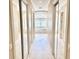 Hallway leading to bath features tile floors, closet with mirrored doors, and lots of natural light at 2280 Mackenzie Ct, Clearwater, FL 33765