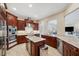 Gourmet kitchen with dark wood cabinetry, granite countertops, stainless steel appliances, and kitchen island at 2280 Mackenzie Ct, Clearwater, FL 33765