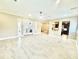Bright living room with elegant tile flooring, ceiling fan, and access to the outdoor patio at 2280 Mackenzie Ct, Clearwater, FL 33765
