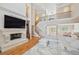 Spacious living room with soaring ceilings, a stone fireplace, and a staircase leading to the second floor at 2280 Mackenzie Ct, Clearwater, FL 33765