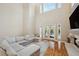Bright living room featuring hardwood floors, high ceilings, fireplace, and access to the outdoor pool area at 2280 Mackenzie Ct, Clearwater, FL 33765