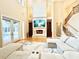 Inviting living room boasting a soaring fireplace, a comfortable sectional, and seamless access to the outdoor pool area at 2280 Mackenzie Ct, Clearwater, FL 33765