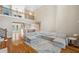 Expansive living room with soaring ceilings, hardwood floors, and an open view to the dining room and staircase at 2280 Mackenzie Ct, Clearwater, FL 33765