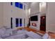 Bright living room with fireplace, staircase, and hardwood floors, complemented by a view of the pool at 2280 Mackenzie Ct, Clearwater, FL 33765