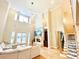 Bright living room featuring high ceilings, a cozy fireplace, and an open layout to the dining and staircase at 2280 Mackenzie Ct, Clearwater, FL 33765